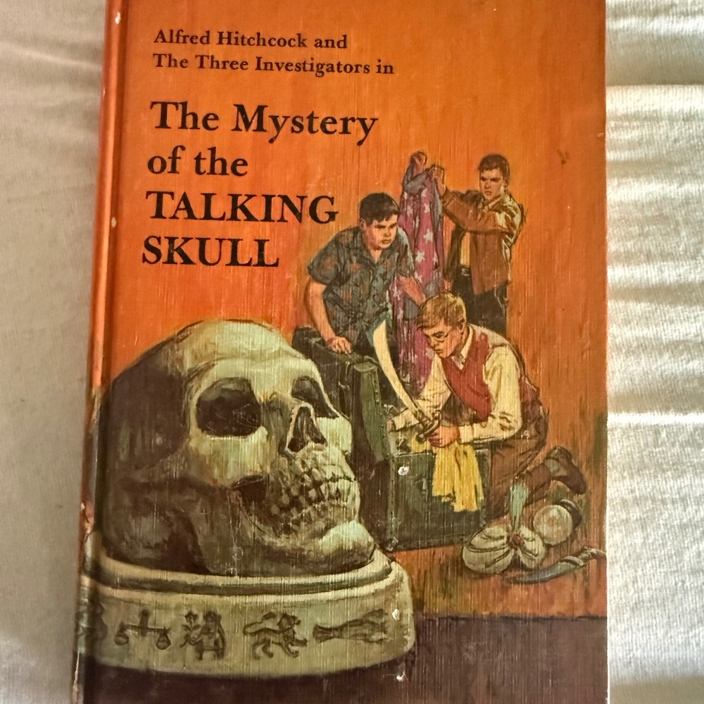 Three investigators talking skull 11 Alfred Hitchcock